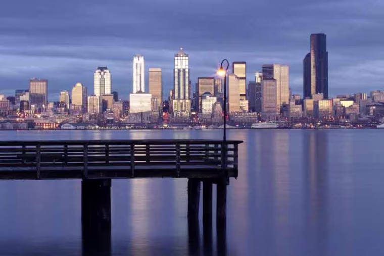 A2KNR4 Seattle skyline and pier in Elliot Bay viewed from West Seattle Seattle Washington USA